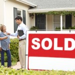 Sign of Sold on the front yard of a house